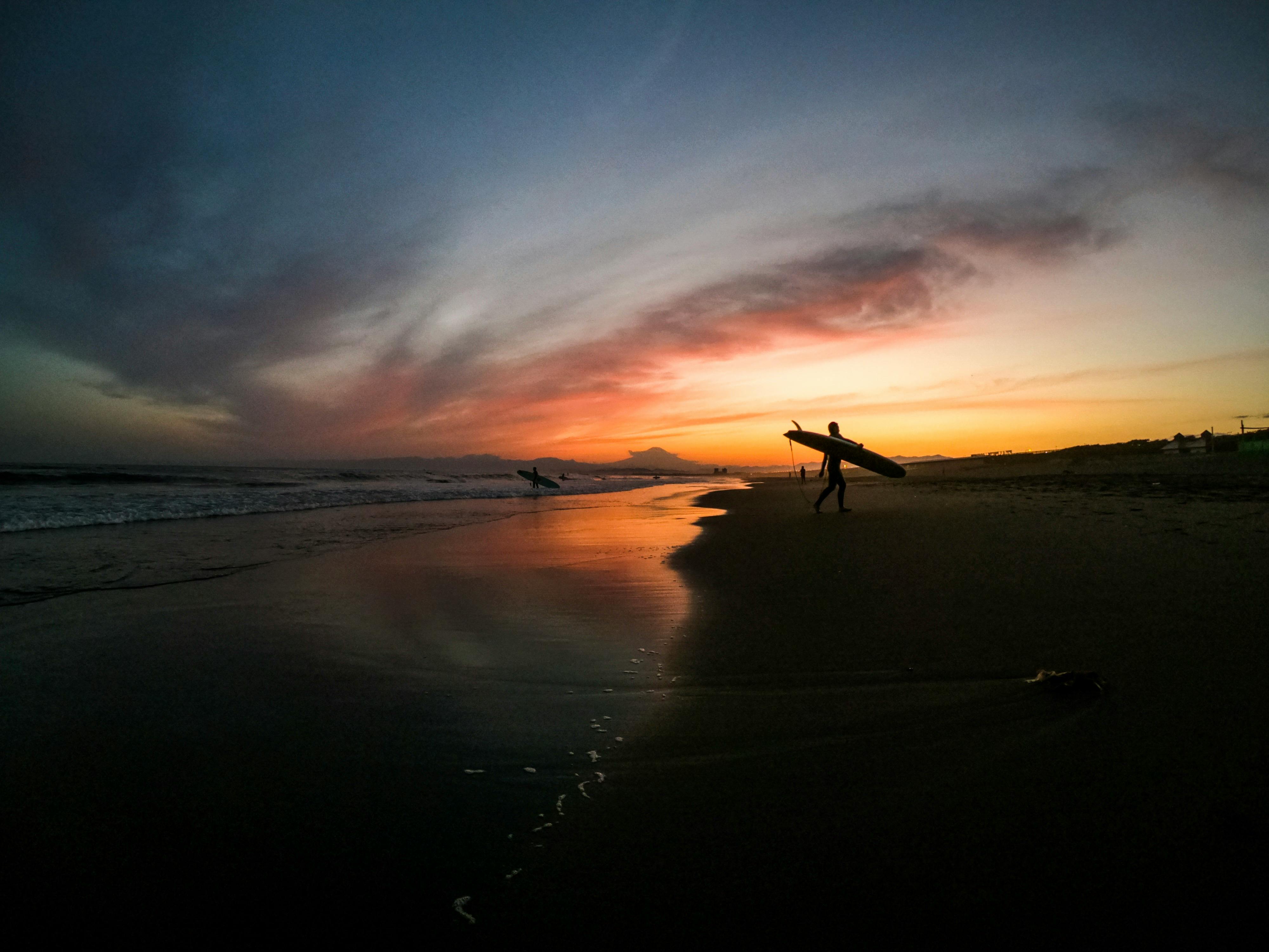 A man with surfboard at beach